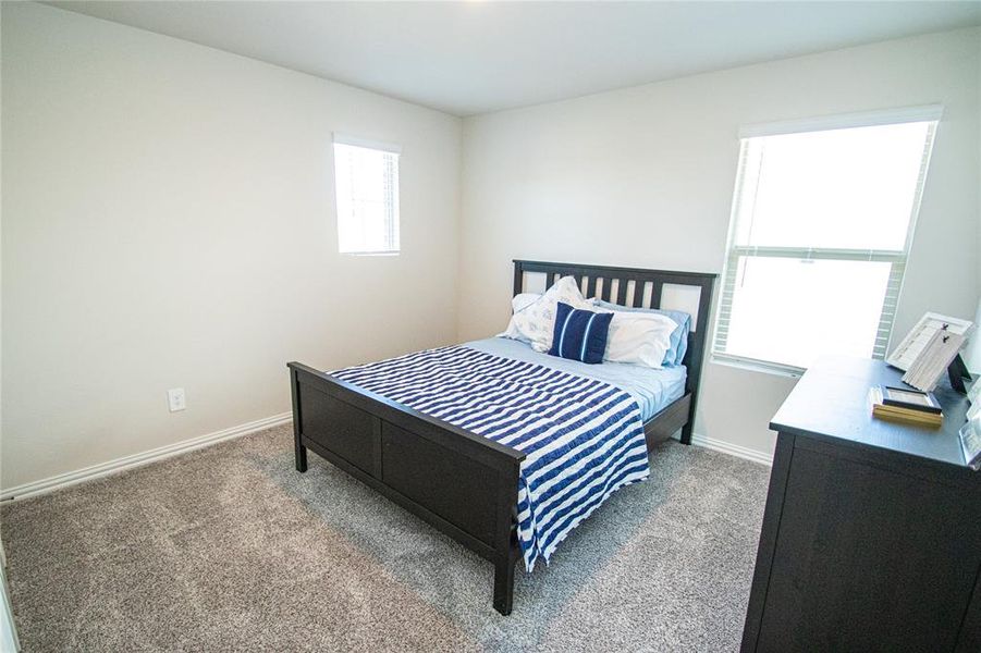 Carpeted bedroom with baseboards Carpeted bedroom with baseboards