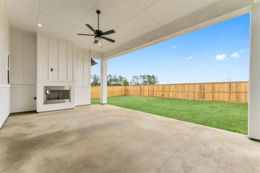 Covered Rear Patio with Woodburning Fireplace and Fan. Outlet Over Fireplace for Your TV!