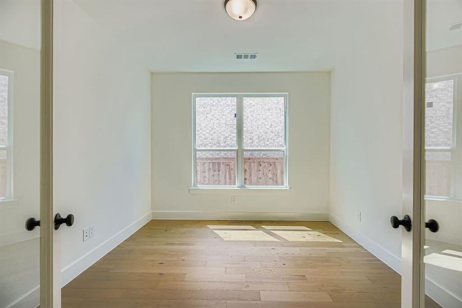 Empty room featuring light wood-style flooring and french doors