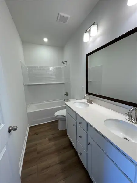 This sleek bathroom features a modern vanity with