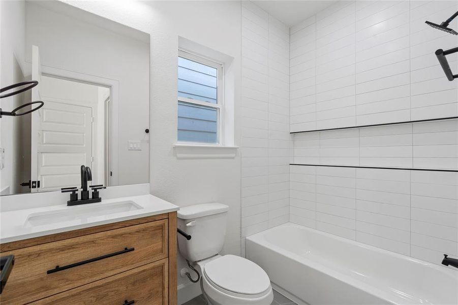 Modern bathroom featuring sleek white subway tiles, a stylish wood vanity with a black faucet, and a clean, bright ambiance. Modern bathroom featuring sleek white subway tiles, a stylish wood vanity with a black faucet, and a clean, bright ambiance.