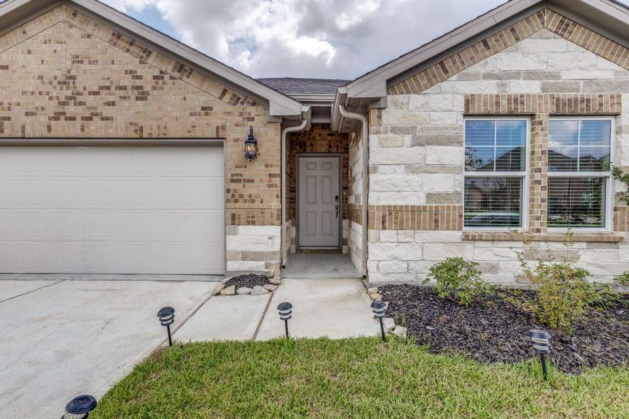 Front exterior of a new home in Sierra Vista, Iowa Colony, TX, highlighting curb appeal (Image 21). Front exterior of a new home in Sierra Vista, Iowa Colony, TX, highlighting curb appeal (Image 21).