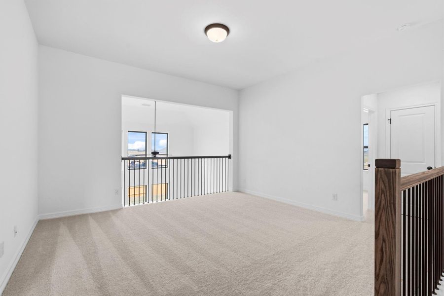 Spacious upstairs game room—perfect for entertaining, play, or relaxing with family.