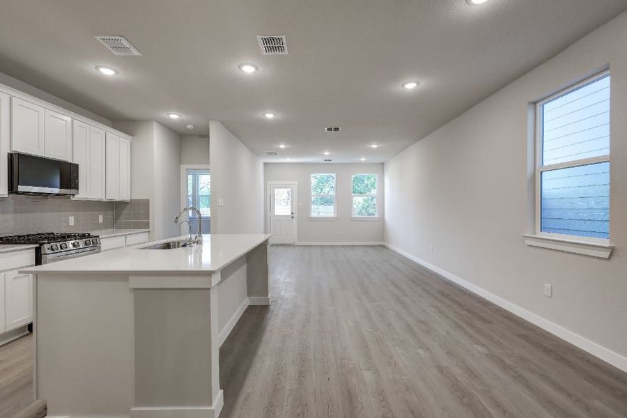 A kitchen with white cabinets. A kitchen with white cabinets.