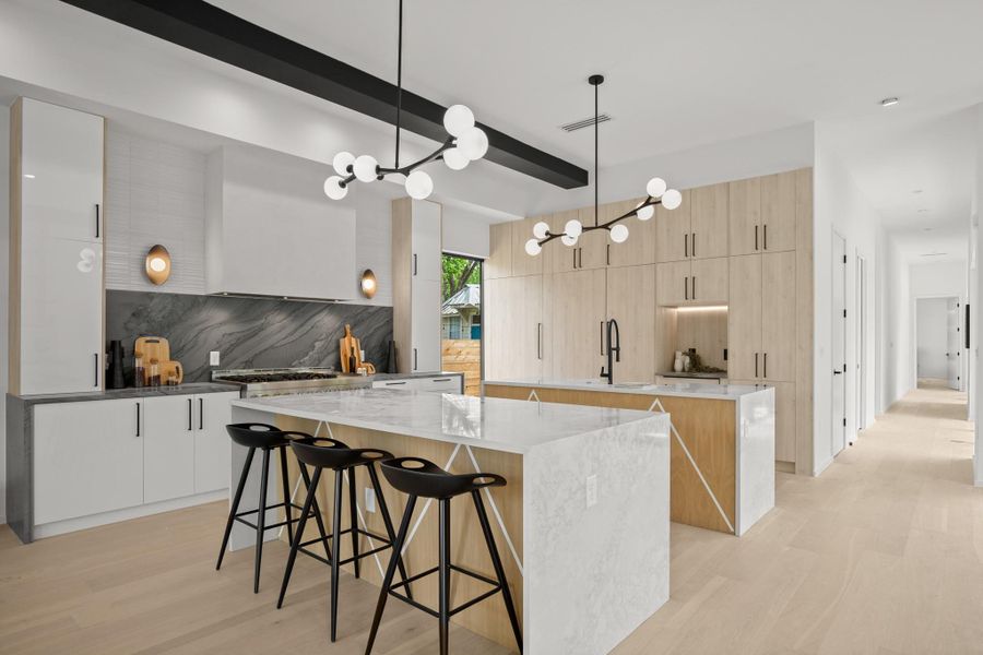Kitchen featuring light wood-style floors, light stone counters, and modern cabinets