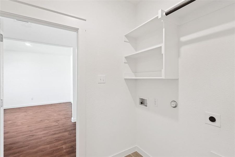 Laundry room featuring dark wood-style floors, hookup for a washing machine, electric dryer hookup, and gas dryer hookup