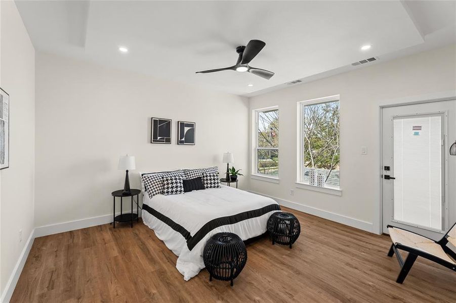 Bedroom featuring wood finished floors, ceiling fan, and recessed lighting