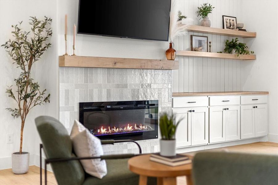 Living room with a fireplace and wood-type flooring