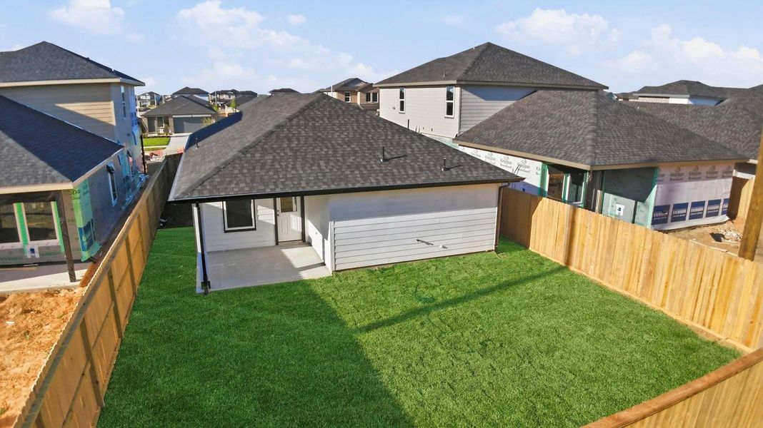 Large fenced-in backyard with a covered patio, perfect for outdoor entertaining.
