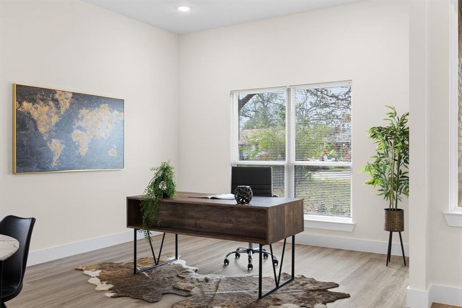 Home office with light hardwood / wood-style flooring