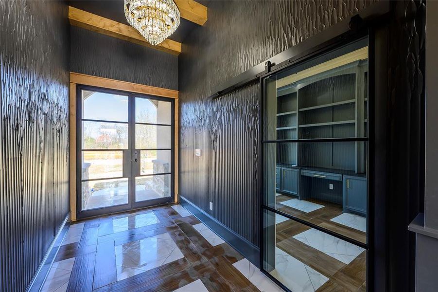 Doorway to outside with hanging lights and a barn door