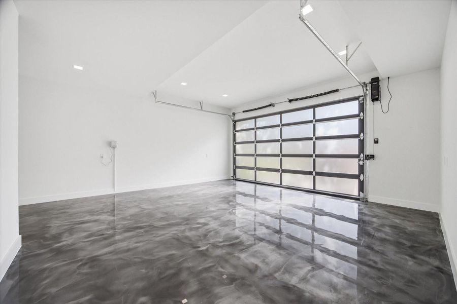 A clean, modern garage space finished with a high-gloss epoxy floor, creating a polished, showroom-quality look.