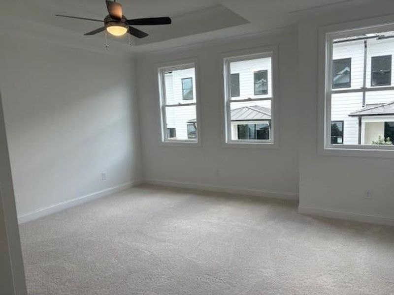 primary bedroom with ceiling fan, cushiony brand new carpet primary bedroom with ceiling fan, cushiony brand new carpet