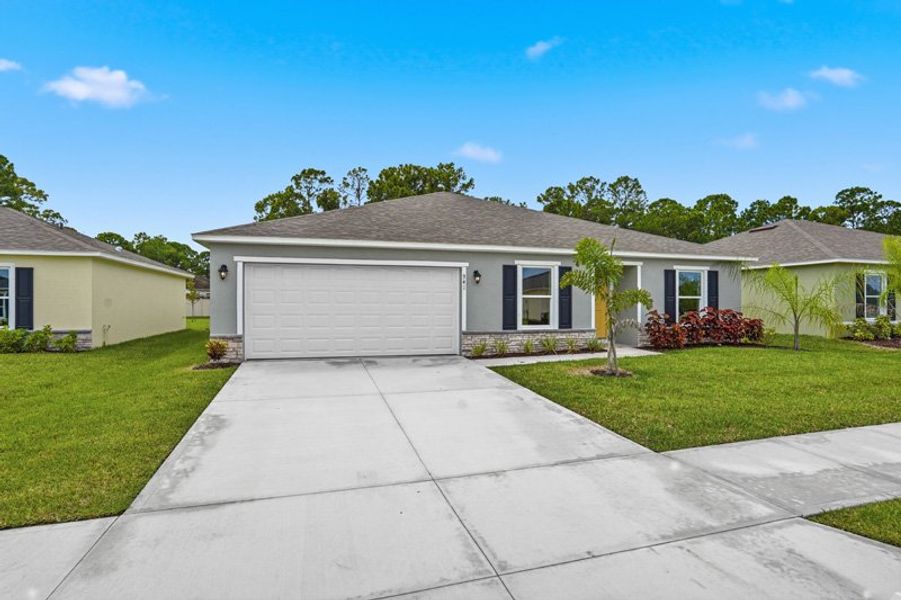Front exterior of a new home in Richmond Cove, Palm Bay, FL, highlighting curb appeal (Image 26). Front exterior of a new home in Richmond Cove, Palm Bay, FL, highlighting curb appeal (Image 26).