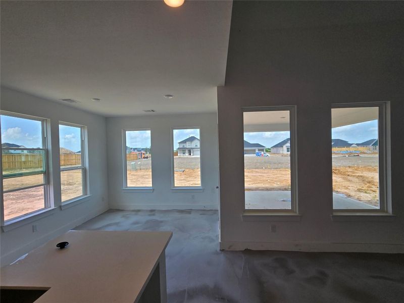 Large windows frame the space, allowing natural light to flood in, casting a cheerful ambiance that makes every meal feel special.