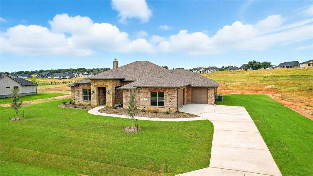 Front exterior of a new home in Rocky Top Ranch, Reno, TX, highlighting curb appeal (Image 19). Front exterior of a new home in Rocky Top Ranch, Reno, TX, highlighting curb appeal (Image 19).