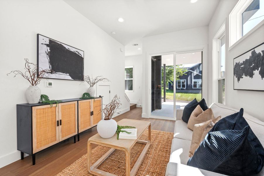 Living area featuring wood finished floors and recessed lighting