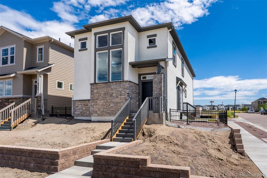 Front exterior of a new home in Revel Crossing at Wolf Ranch – The Ascent Collection, Colorado Springs, CO, highlighting curb appeal (Image 2).