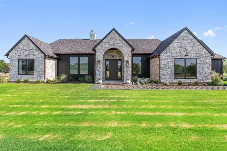 French provincial home with a front lawn