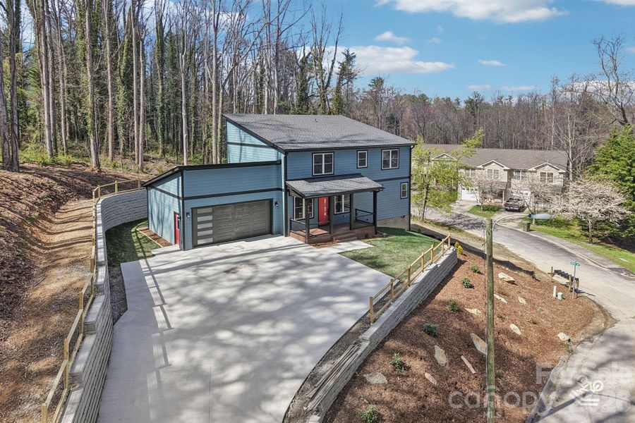 Front exterior of a new home in , Hendersonville, NC, highlighting curb appeal (Image 25).