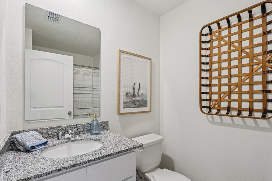 A bathroom with a sink and a mirror. A bathroom with a sink and a mirror.