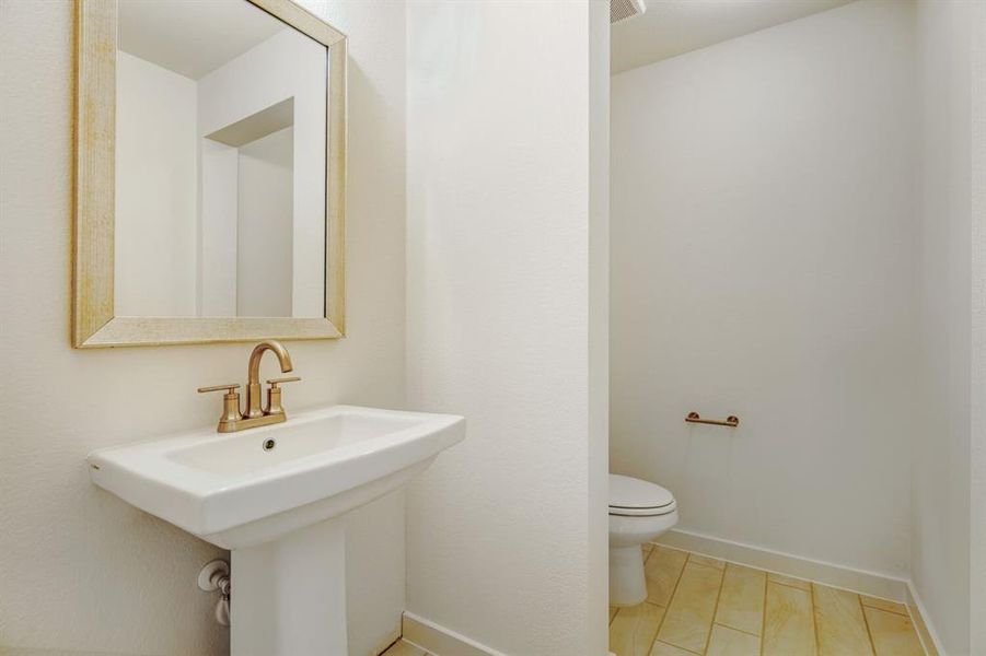Bathroom with toilet and baseboards