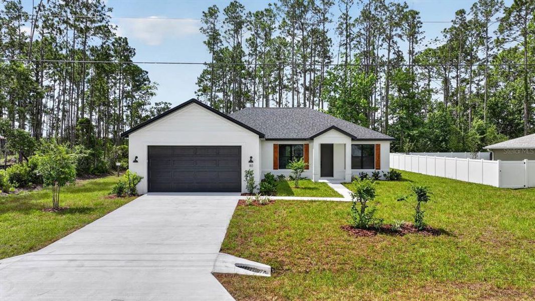 Front exterior of a new home in , Palm Coast, FL, highlighting curb appeal (Image 2). Front exterior of a new home in , Palm Coast, FL, highlighting curb appeal (Image 2).
