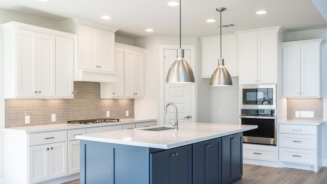 Kitchen with stainless steel appliances, a sink, white cabinets, tasteful backsplash, and recessed lighting Kitchen with stainless steel appliances, a sink, white cabinets, tasteful backsplash, and recessed lighting