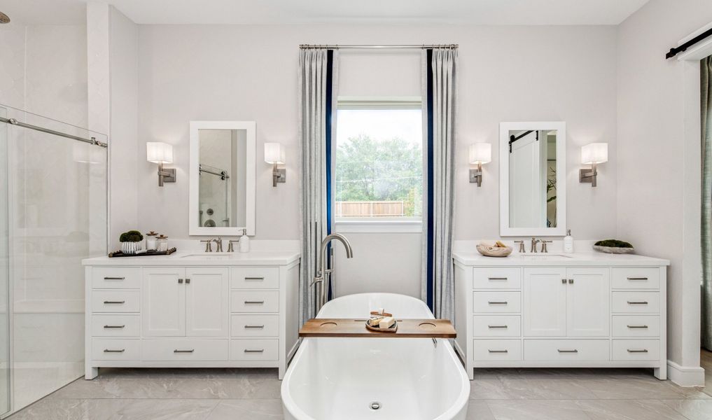 Primary bath with dual freestanding vanities Primary bath with dual freestanding vanities