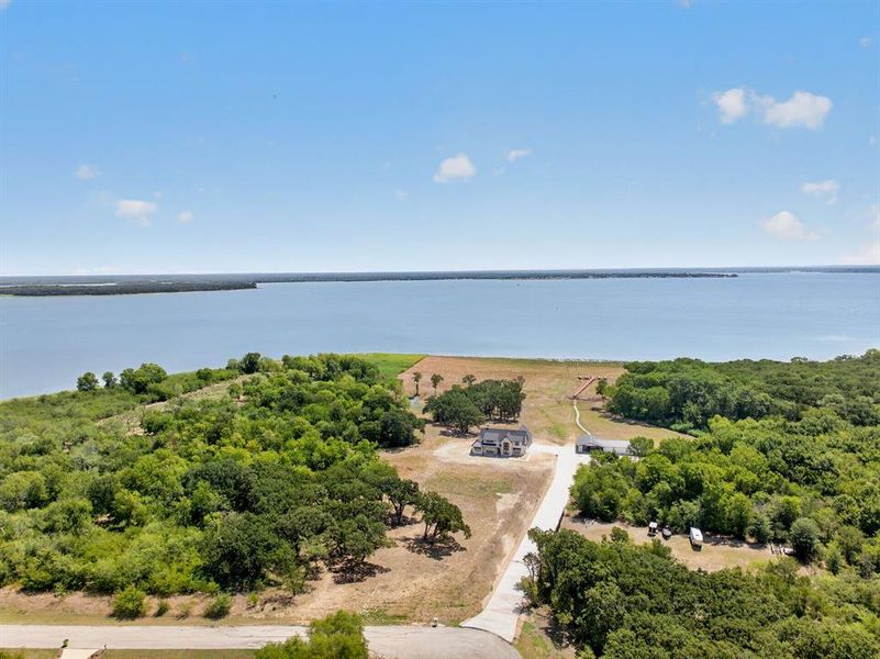 Breathtaking wide aerial view highlighting the homes spectacular view of the 1.56 acres and 189 feet of pristine water frontage. Breathtaking wide aerial view highlighting the homes spectacular view of the 1.56 acres and 189 feet of pristine water frontage.