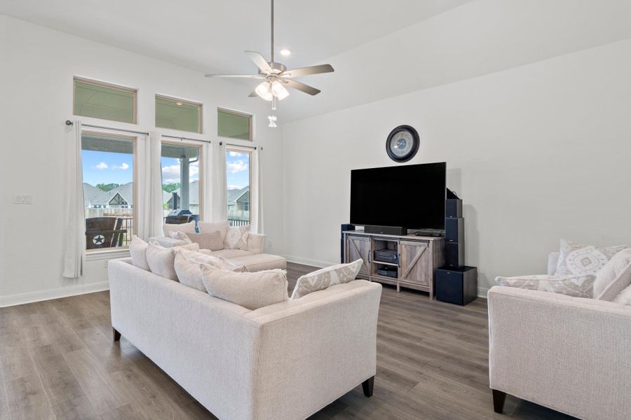The wall of oversized windows provides a picturesque view of the backyard.
