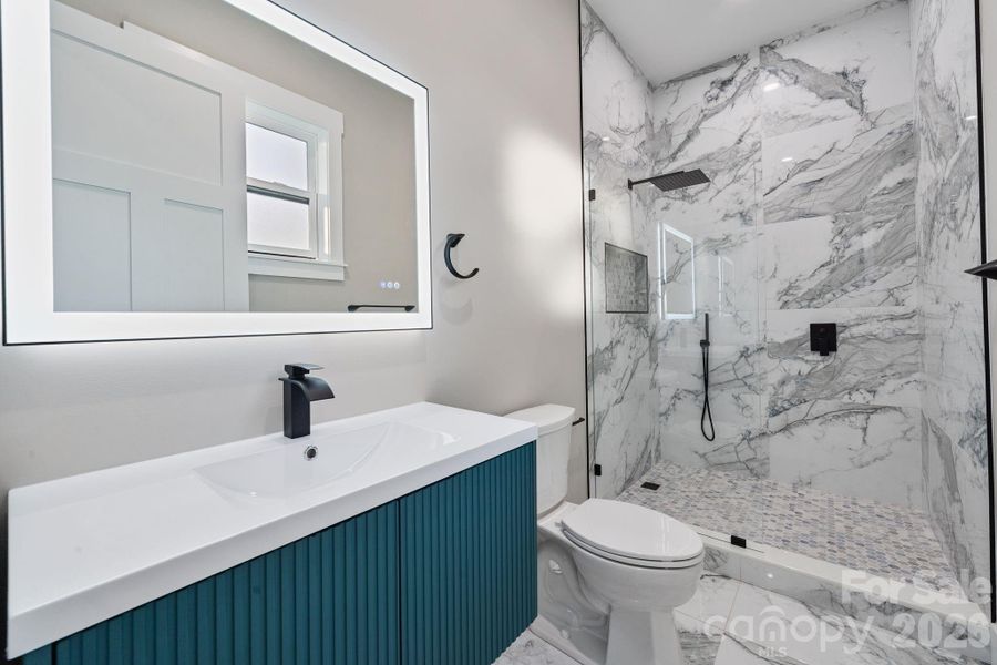 Floating vanity, LED mirror and tile shower