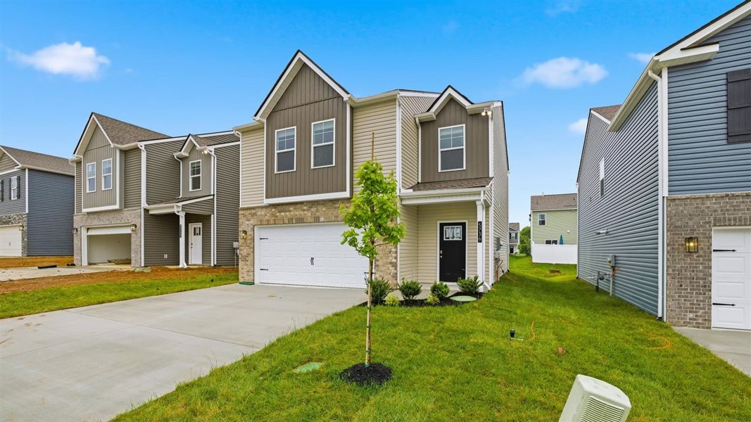Front exterior of a new home in Price's Point, Knoxville, TN, highlighting curb appeal (Image 2). Front exterior of a new home in Price's Point, Knoxville, TN, highlighting curb appeal (Image 2).