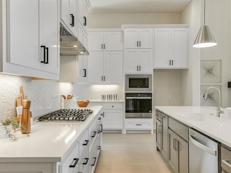 An entertainer's dream kitchen, complete with buffet-style cabinetry and countertops, and effortless flow to the living and dining areas.