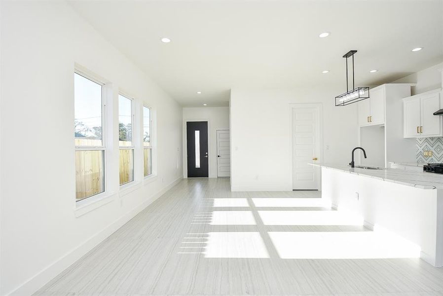 Upon entering, you're greeted by stunning floors, soaring ceilings, and abundant recessed lighting, creating a bright atmosphere. The open-concept layout seamlessly connects the living, dining, and kitchen areas for effortless modern living.