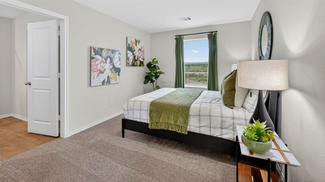 Carpeted room with a rectangular window, a two-panel interior door, and light gray wall paint Carpeted room with a rectangular window, a two-panel interior door, and light gray wall paint
