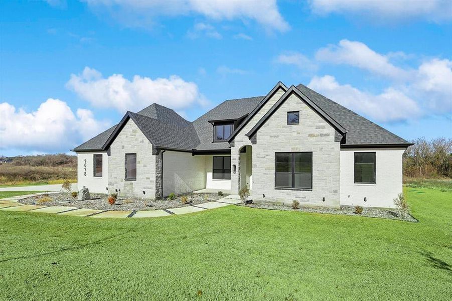 Rear view of house with a lawn