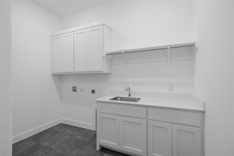 Laundry area with cabinet space, hookup for a washing machine, electric dryer hookup, and hookup for a gas dryer