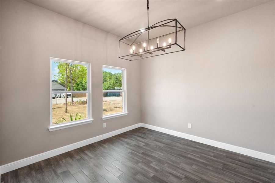 Dining room featuring chandelier and natural light facing front of the home