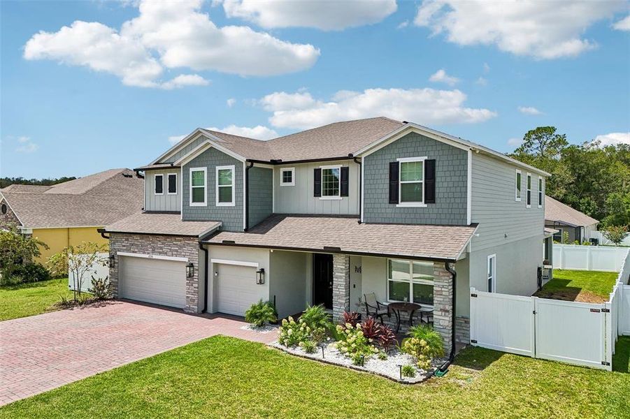 Front exterior of a new home in Elegant Manor Estates, Edgewater, FL, highlighting curb appeal (Image 25). Front exterior of a new home in Elegant Manor Estates, Edgewater, FL, highlighting curb appeal (Image 25).