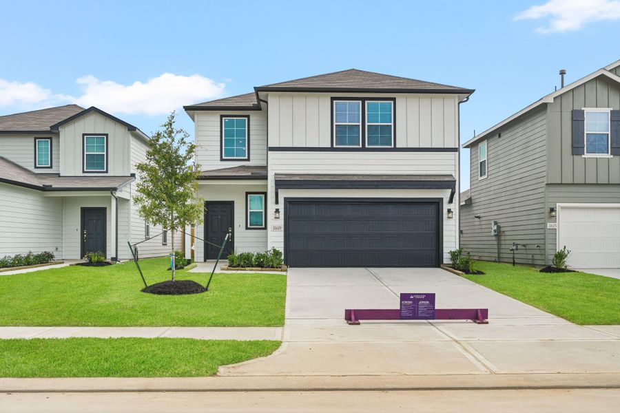 Front exterior of a new home in Barrett Crossing, Crosby, TX, highlighting curb appeal (Image 2). Front exterior of a new home in Barrett Crossing, Crosby, TX, highlighting curb appeal (Image 2).