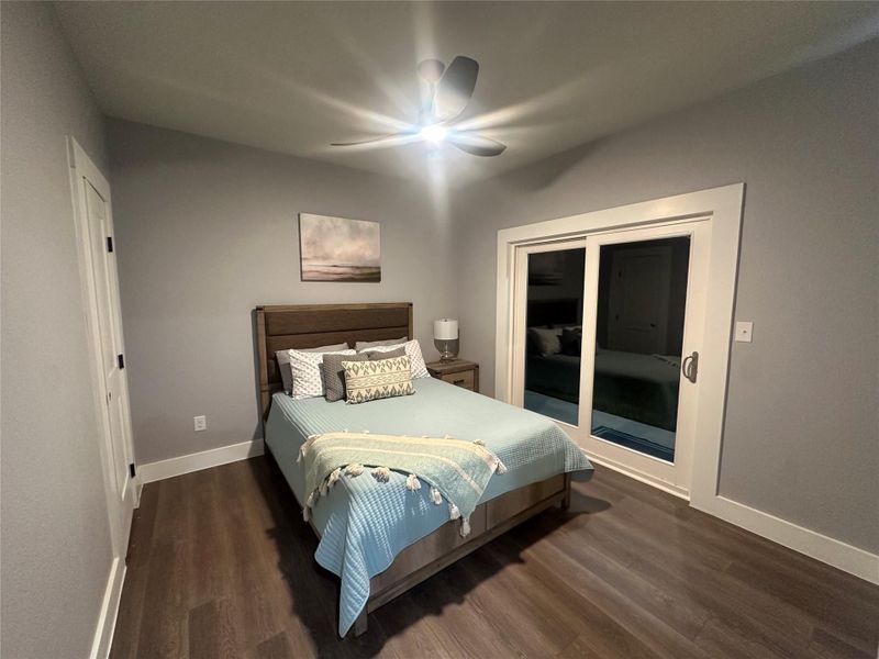 Guest bedroom number 2 with covered porch and private sliding glass doors to lake. Guest bedroom number 2 with covered porch and private sliding glass doors to lake.