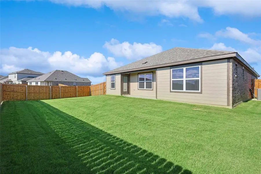 Rear view of property with a yard