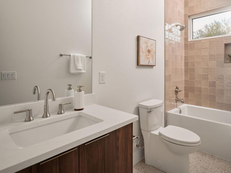 Full bathroom featuring vanity, dark speckled floor, and shower / bathtub combination Full bathroom featuring vanity, dark speckled floor, and shower / bathtub combination