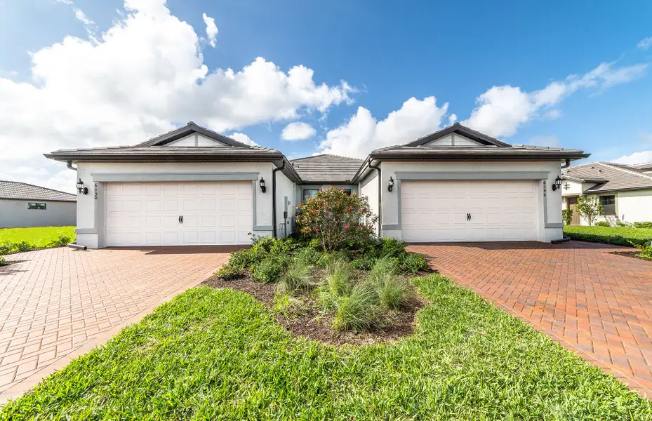 Attached villa exterior with a 2-car garage