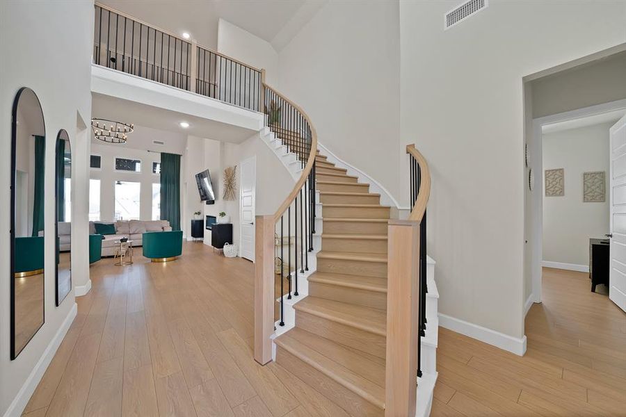 Curved staircase with wood treads and black iron balusters Curved staircase with wood treads and black iron balusters