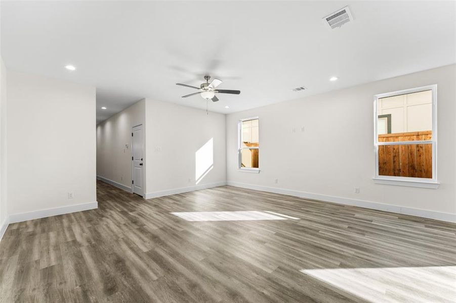 Unfurnished room with recessed lighting, healthy amount of natural light, ceiling fan, and wood like floors Unfurnished room with recessed lighting, healthy amount of natural light, ceiling fan, and wood like floors