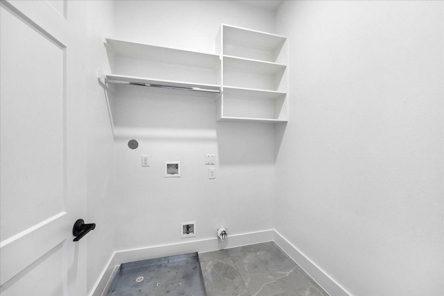 Dedicated utility room offers additional storage, generous workspace, and a thoughtfully designed layout that keeps everyday tasks organized and out of sight.