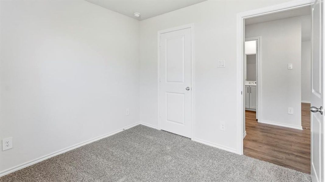 Unfurnished bedroom with baseboards and dark colored carpet Unfurnished bedroom with baseboards and dark colored carpet