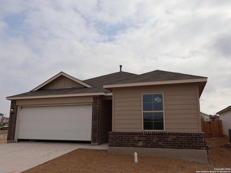 Front exterior of a new home in Agave, San Antonio, TX, highlighting curb appeal (Image 18).